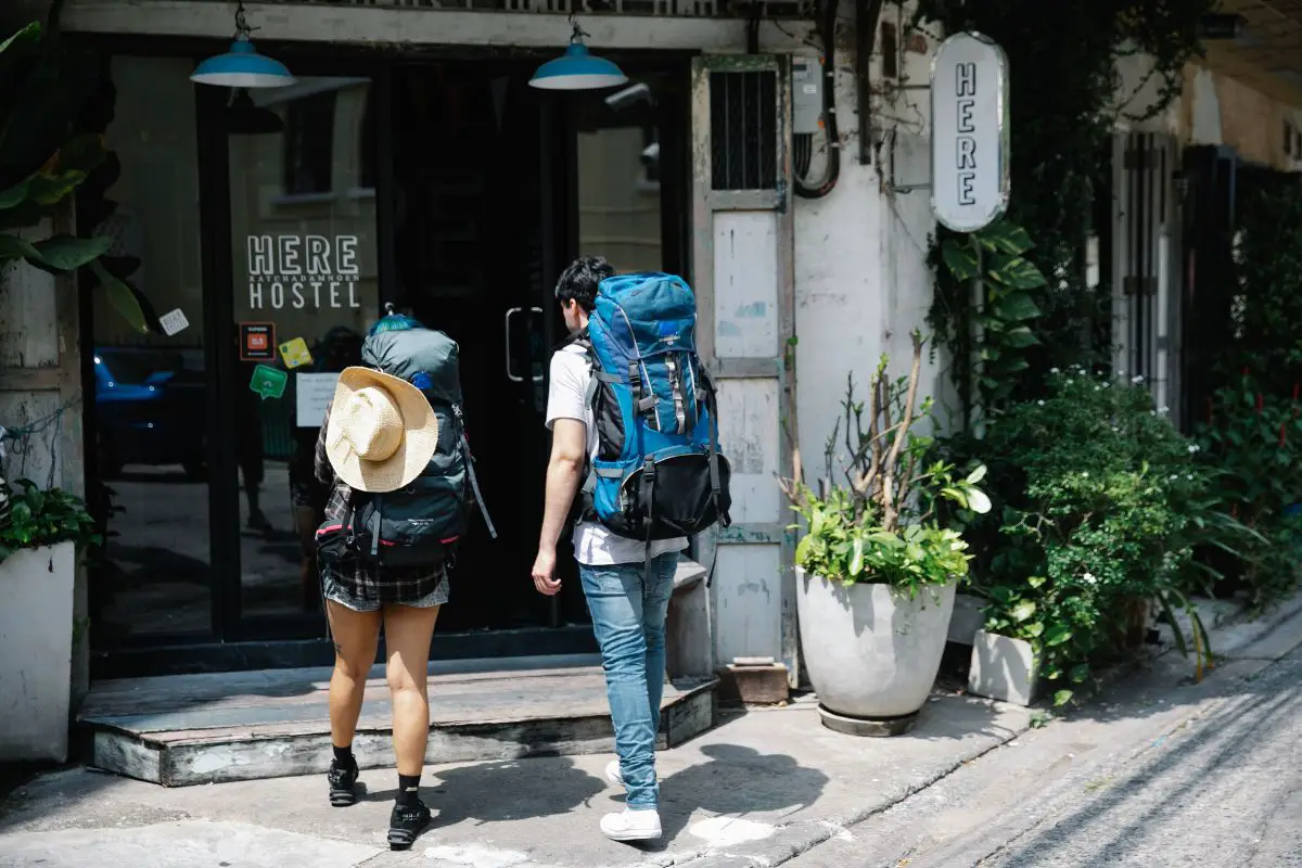 backpackers entering a hostel